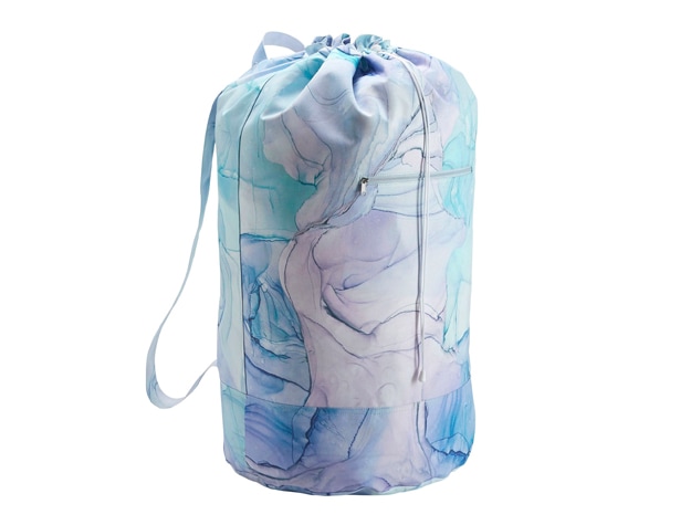Recycled XL Essential Laundry Backpack on a wood floor.