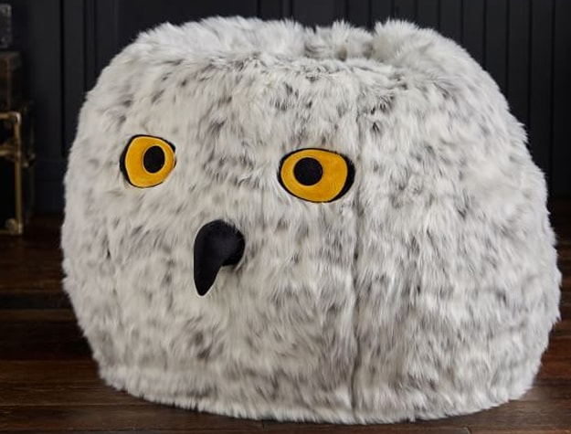 A faux-fur bean bag inspired by Hedwig sits in a room.