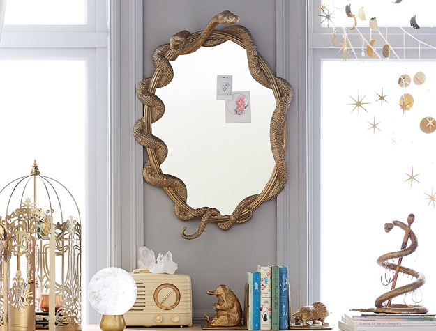 A mirror inspired by Harry Potter’s Nagini hangs on a wall.