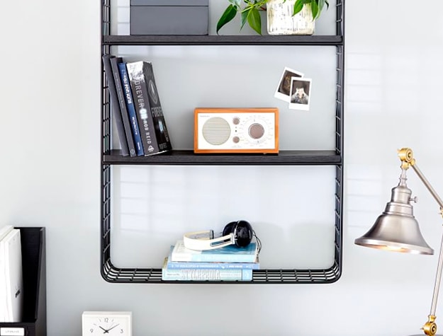 black wire shelves with books and radio