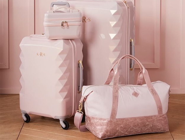 Light pink luggage and travel bags