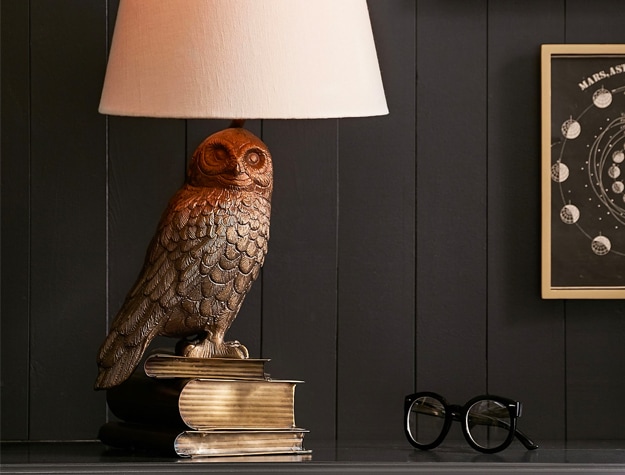 Harry Potter Hedwig thematic task lamp on a desk next to a pair of glasses.