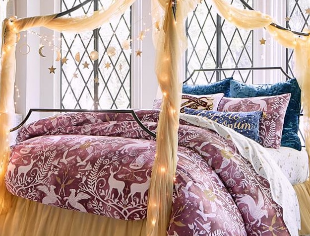 A burgundy duvet cover bears magical creatures from Harry Potter amidst a damask design.