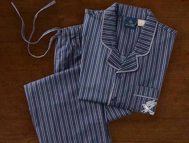 A pajama set inspired by Ravenclaw House sits atop a wooden backdrop.