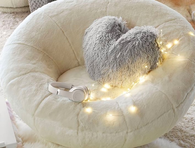 twinkle lights on fuzzy white lounge chair