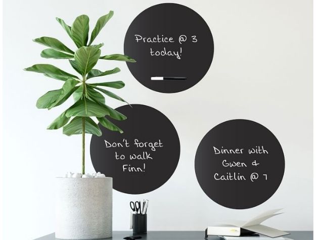 Three black dry erase dot decals on wall