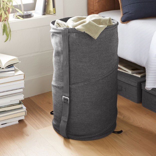 Gray pop up hamper in college dorm 