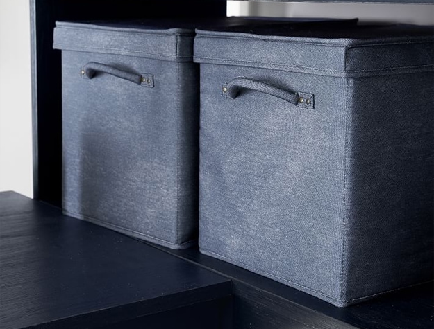 Blue cloth storage boxes on dark flooring