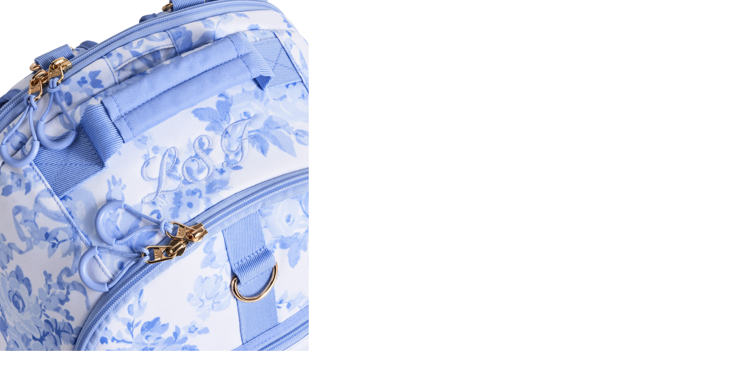 Gallery of five images showing the Gear-Up Adaptive Backpack's main features, including smooth-glide zipper pulls; insulated front pockets; access ports for tubes and cables; a roomy interior with pockets for hanging feeding bags, equipment and school essentials; and versatile mounting options for mobility devices. This image displays the smooth-glide zipper pulls feature.