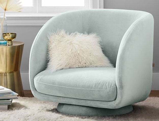teal lounge chair with throw pillow