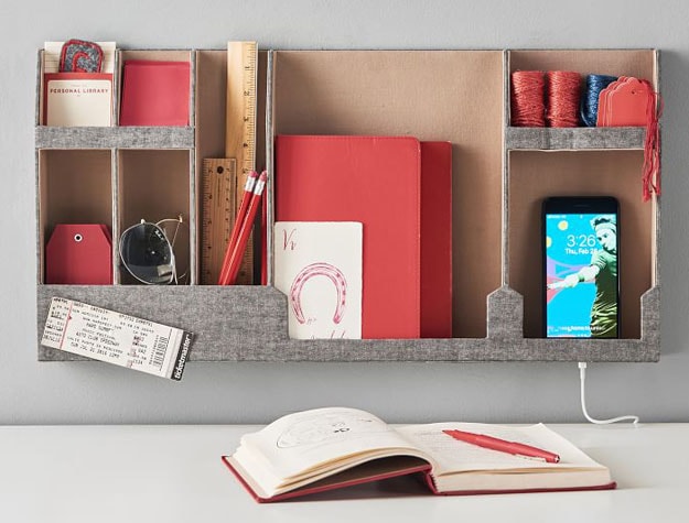 grey wall organizer with red supplies