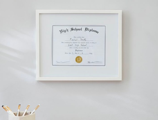 White diploma frame on wall