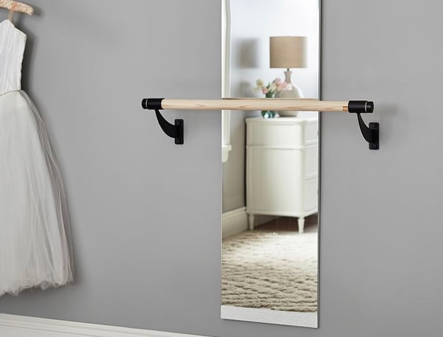 Ballet barre mounted on wall and mirror