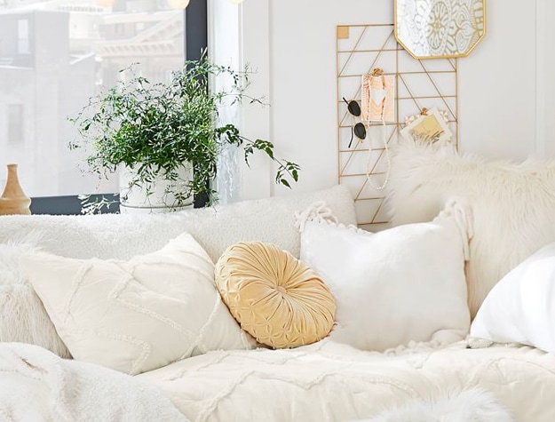 Decorative pillows on white bed