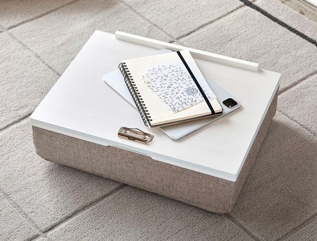 White lap desk with notebooks on top