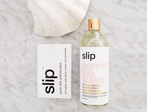 Slip brand gentle skin wash set on marble counter next to seashell