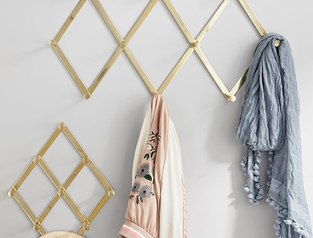 Gold accordion wall hooks with hanging scarves