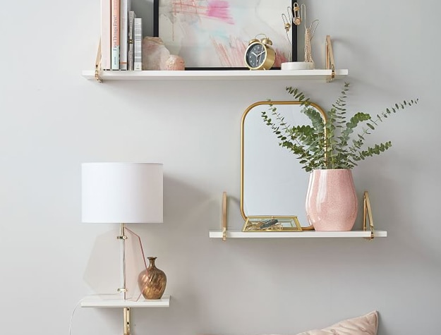Plant and painting on floating white shelves