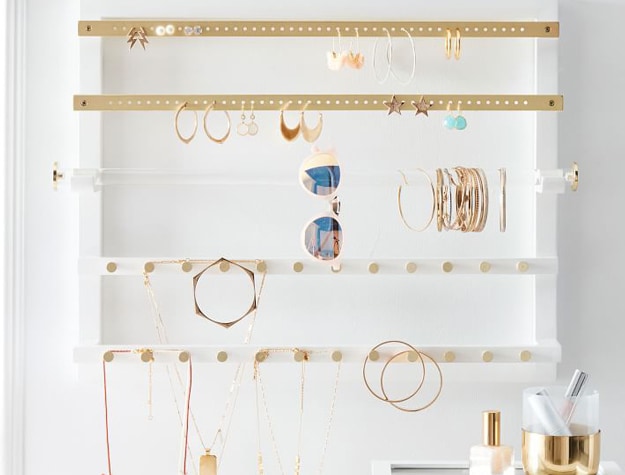 White and gold jewel display rack on wall