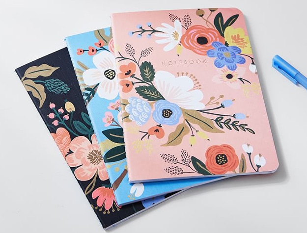 Stack of flower illustrated notebooks