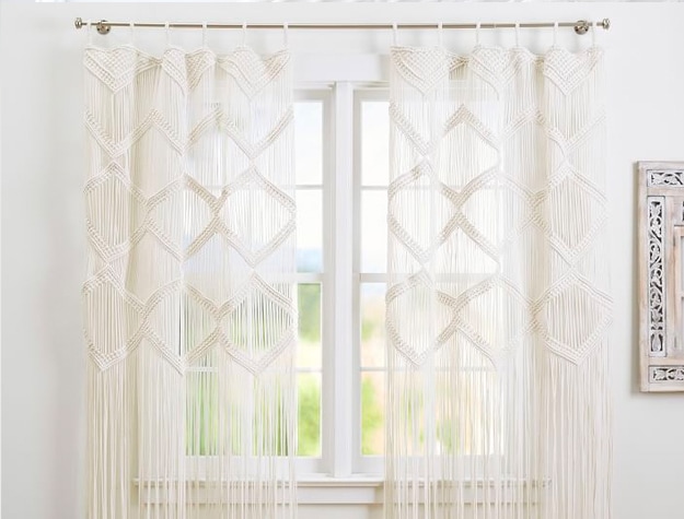Boho Macrame Decorative Panels hanging on a curtain rod in front of a window.
