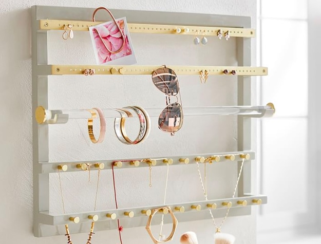Jewelry and accessories hanging on a Elle Lacquer Wall Jewelry Organizer.