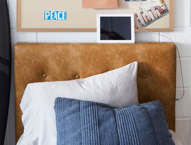 Bed with a Brown Vegan Leather Tufted Smart Faux Headboard.