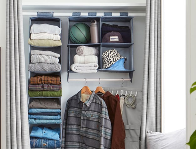 Closet with an RPET Hanging Closet Sweater Organizer and hanging clothes.