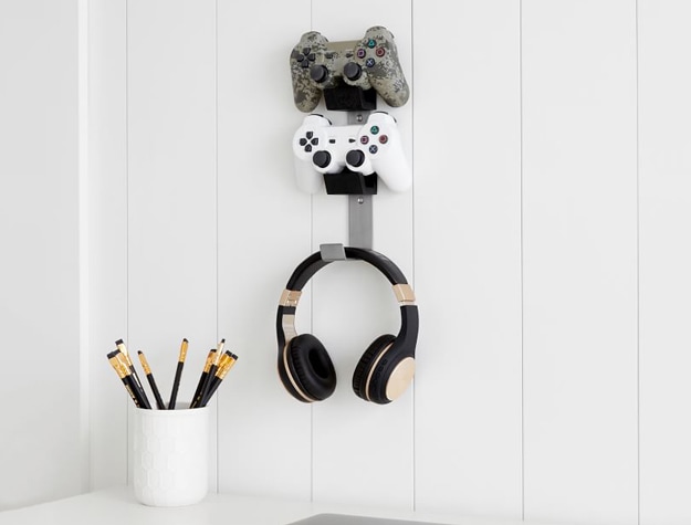 Two gaming controllers hanging on the wall.
