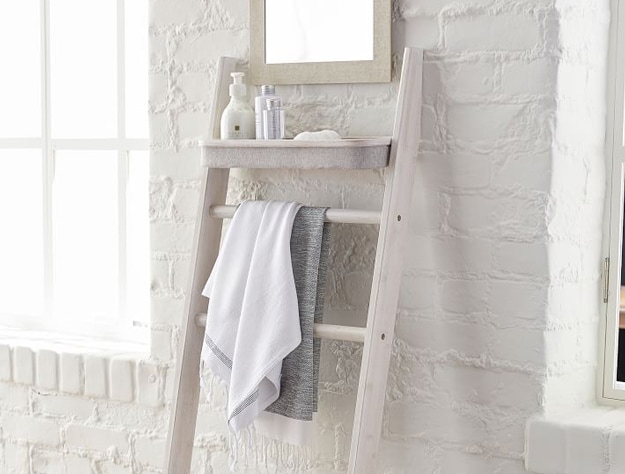 Hanging shelf with bath towels and bathing products.
