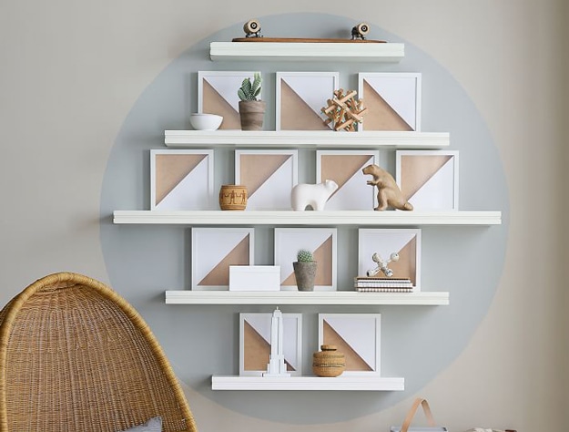 White picture frames on a wood ledge.