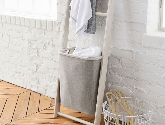 Floating shelf rack with attached laundry basket.