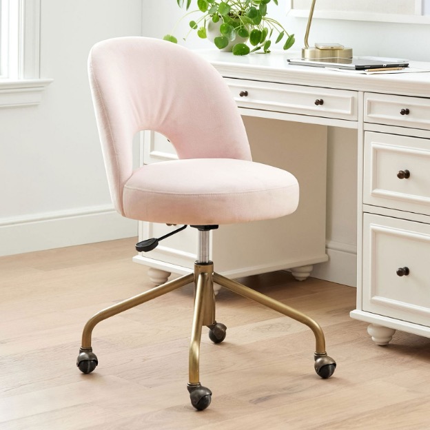 A pink swivel desk chair is shown next to a desk.