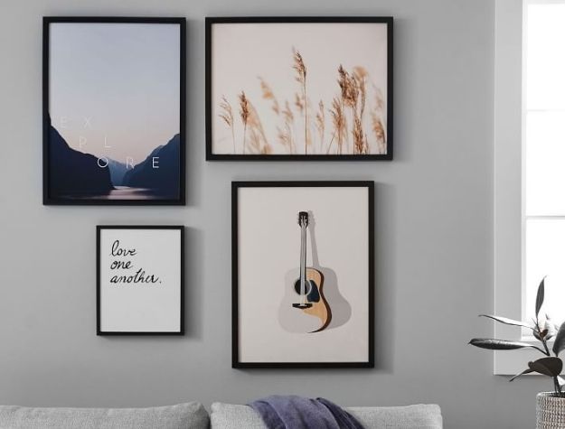 framed prints hung above couch