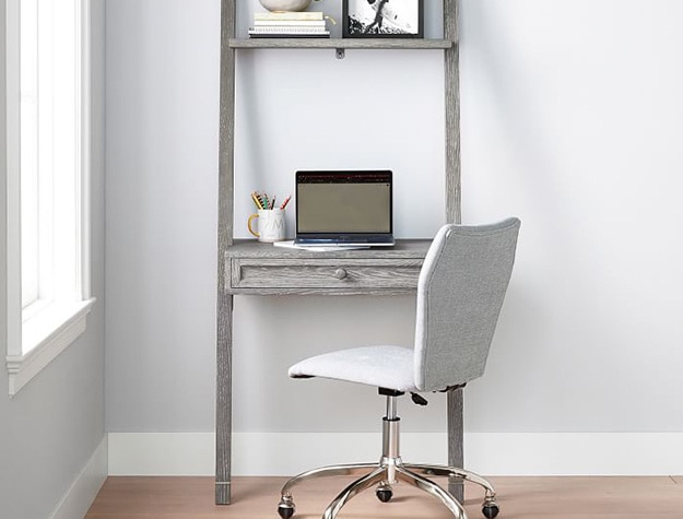 Beadboard leaning wall desk with laptop.