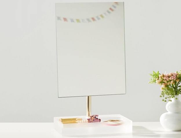 Acrylic mirror and jewelry tray on table