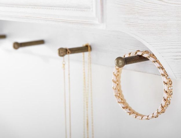 Wall hooks displaying necklaces and bracelet