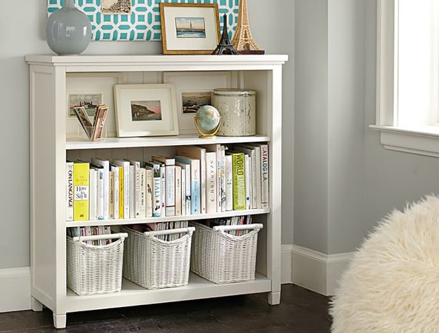 Beadboard wide bookcase filled with books.