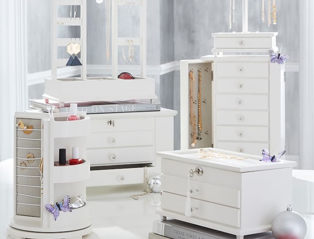 White jewelry display cases with earrings, necklaces and bracelets
