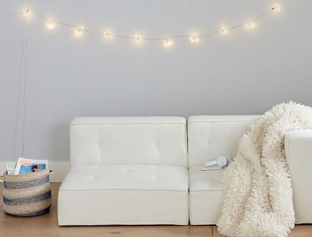 Starburst string lights hanging above sofa.