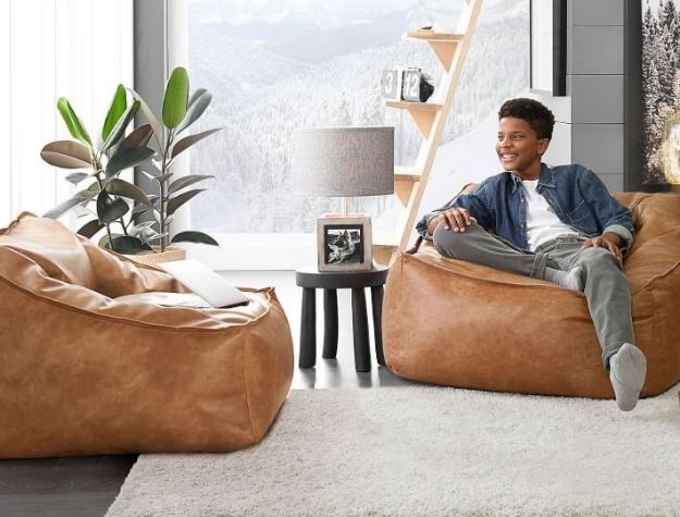 guy sitting in bean bag chair on top of shag rug