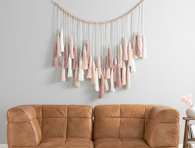 Oversized tassel garland hanging over sofa.