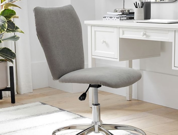 Grey swivel office chair in front of desk Grey swivel office chair in front of desk