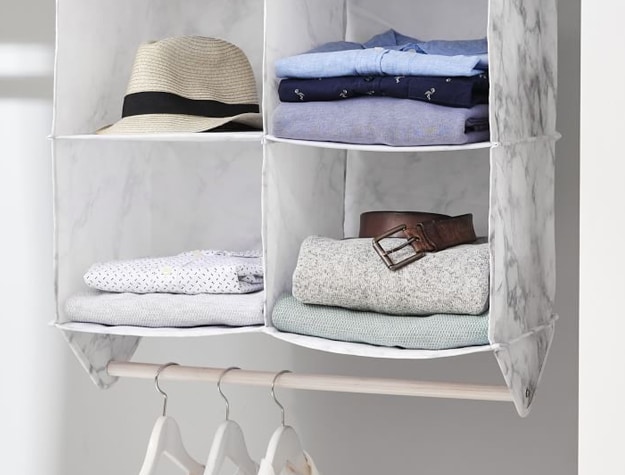 Marble-print smart organizer filled with clothing and accessories