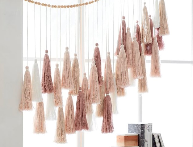 Neutral tassel garland hanging in window Neutral tassel garland hanging in window