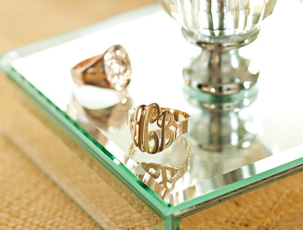Two monogrammed rings on mirrored base Two monogrammed rings on mirrored base