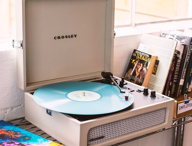 White record player next to books White record player next to books