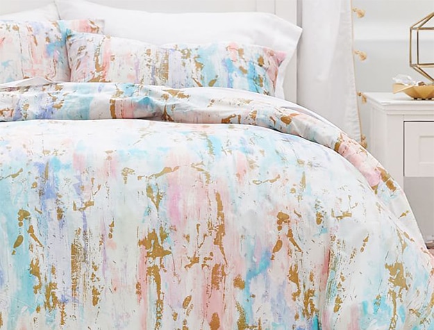 Pastel pink, purple and blue duvet set with gold details.