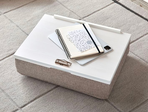 White lap desk with notebooks on top White lap desk with notebooks on top
