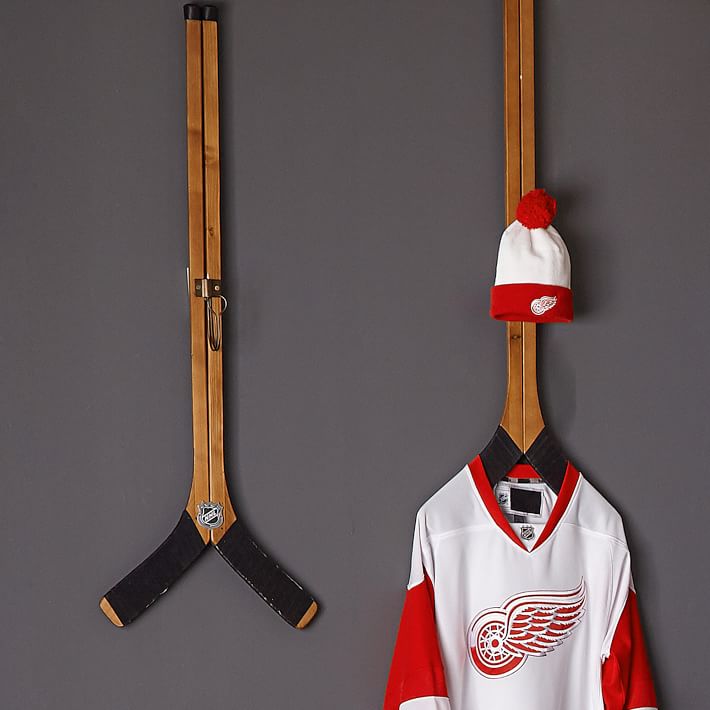 hanging hockey sticks on wall